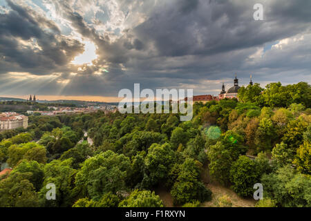 View of Prague taken from Nuselsky bridge on sunset captures typical local architecture from aerial perspective. Famous Vysehrad Stock Photo