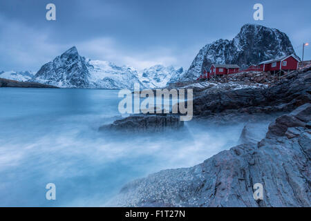 Dusk light on the typical red houses and rough sea, Hamnoy, Lofoten Islands, Northern Norway, Scandinavia, Arctic, Europe Stock Photo