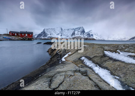 Typical landscape of Hamnoy with red houses of fishermen and the snowy mountains, Lofoten Islands, Norway, Scandinavia, Arctic Stock Photo