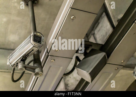 Closeup of a fixed metallic colored CCTV camera and public address system Stock Photo