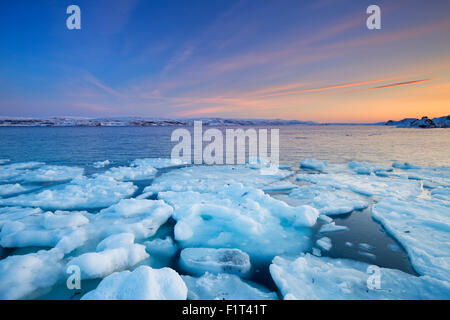 Ice floes on the Arctic Ocean in Norway, photographed at the Porsangerfjord in Norway at sunset. Stock Photo