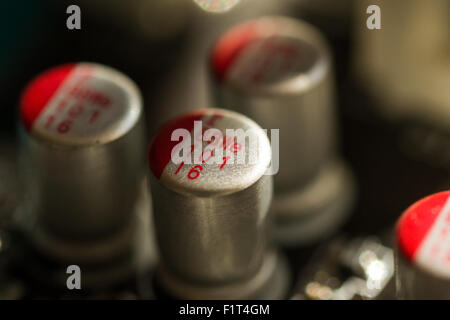 Macro shot of three electrical resistors on a printed circuit board with dark shadow and little light Stock Photo