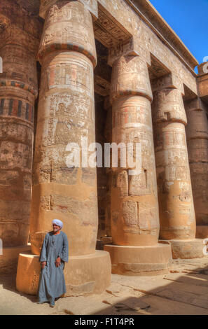 Local man, Columns in the Great Hypostyle Hall, Karnak Temple, Luxor, Thebes, UNESCO World Heritage Site, Egypt, North Africa Stock Photo