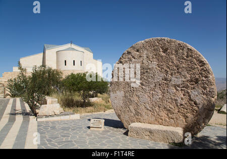 Abu Badd, a rolling stone used to fortify a door, Moses Memorial Church in the background, Mount Nebo, Jordan, Middle East Stock Photo