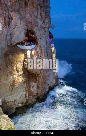 Bar built in cliff caves, Cova d'en Xoroi in evening, Cala en Porter, Menorca, Balearic Islands, Spain, Mediterranean, Europe Stock Photo