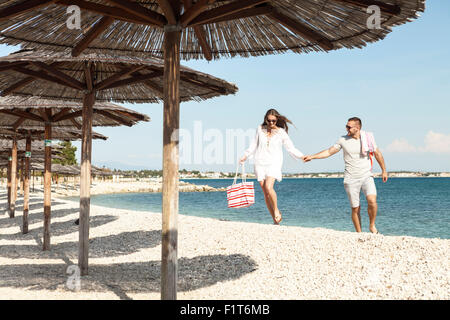 Young couple walking on beach Stock Photo