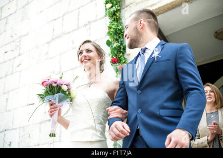 Bride and groom leaving chapel Stock Photo