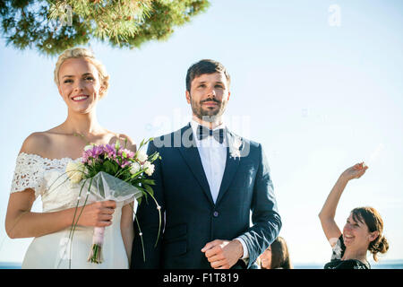 Portrait of bride with bouquet and groom Stock Photo