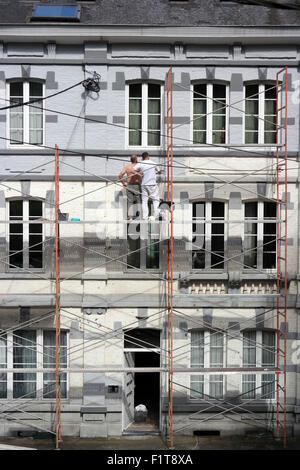 Two men working on scaffolding in the Belgian town La Roche Stock Photo