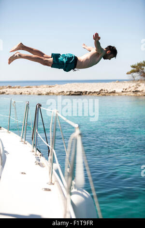 Young diver plunge into the water with scuba Vector Image