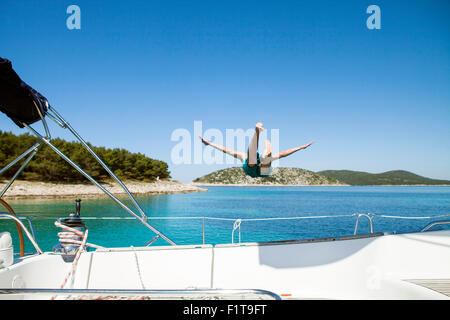 Young man diving into water from sailboat, Adriatic Sea
