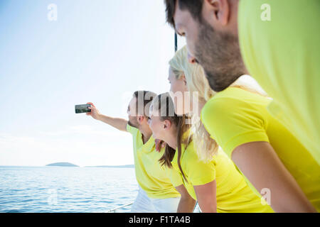 Group of friends taking pictures on sailboat, Adriatic Sea Stock Photo