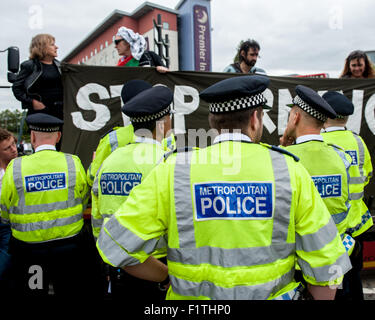 London, UK. 7th September, 2015. Activists block the delivery of a military vehicle during a protest against the DSEI, one of the world’s largest arms fairs. Activists are angered by the impact they claim the fair has on the “arms trade and repression.” The protesters aim to hold a week of action against the fair to disrupt the smooth running of the event which is scheduled to take place from the 15th to the 18th of September 2015 at the ExCel Centre, Royal Victoria Dock. Credit:  Pete Maclaine/Alamy Live News Stock Photo