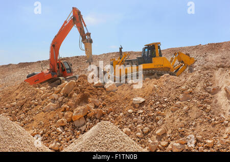 Loader machines in construction site loading soil Stock Photo