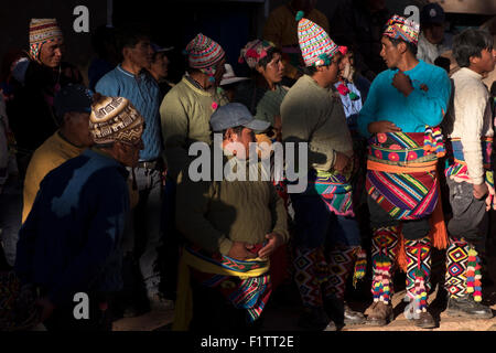 Several men waiting for new fights are initiated during the celebration of Tinku. Stock Photo