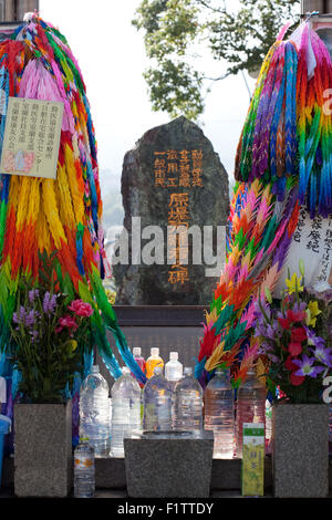 water left at memorial to the atomic bomb victims of Nagasaki in Nagasaki Peace Park, Japan,to re Stock Photo