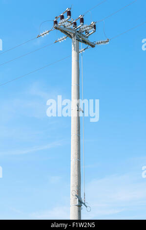 Power isolator switch manual on electrical pylon against the blue sky Stock Photo