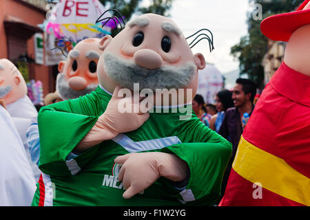 COSTUMED MEN in a parade during the July GUELAGUETZA FESTIVAL  - OAXACA, MEXICO Stock Photo