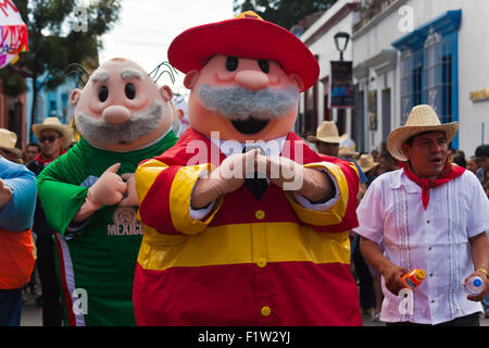 COSTUMED MEN in a parade during the July GUELAGUETZA FESTIVAL  - OAXACA, MEXICO Stock Photo