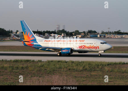 Low cost air travel. Jet2 Holidays Boeing 737-300 commercial passenger jet aircraft taking off from Malta Stock Photo