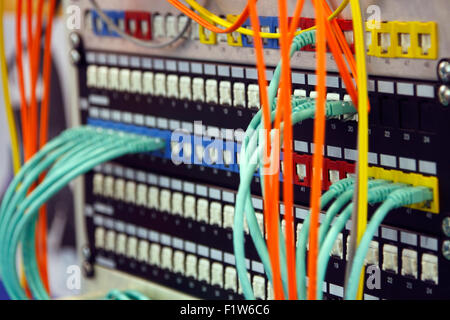 Network switching hardware with cables connected Stock Photo