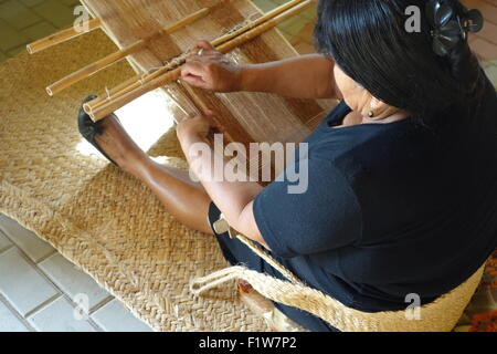 A Peruvian lady uses her hand loom to weave elaborate traditional ...