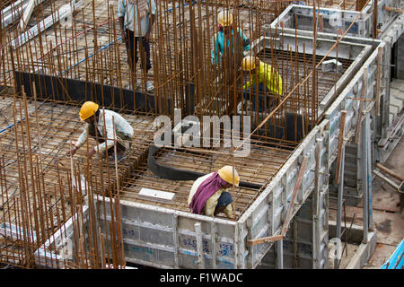 Unidentified workers are employed in construction overhead metro in Bangalore City Stock Photo