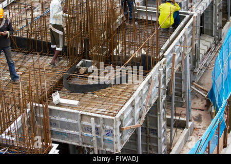 Unidentified workers are employed in construction overhead metro in Bangalore City Stock Photo