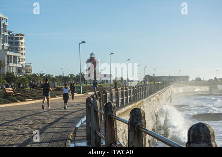 People jogging and walking along the Mouille Point promenade in Cape Town Stock Photo