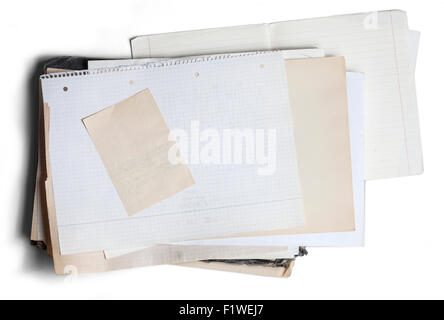 Sheet of yellowed and square graph paper on pile of aged papers Stock Photo