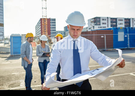 architect with blueprint on construction site Stock Photo