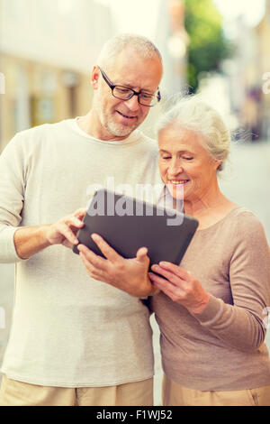 senior couple photographing on city street