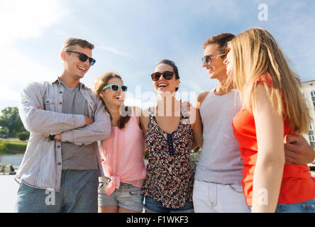 group of smiling friends in city Stock Photo