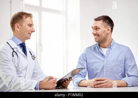 male doctor and patient with clipboard at hospital Stock Photo