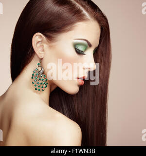 Portrait of beautiful brunette woman with earring. Perfect makeup. Fashion photo Stock Photo