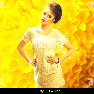 Young fresh lady over the deep yellow background Stock Photo