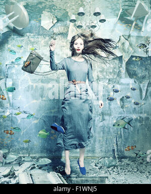 a pretty woman underwater in the flooded interior. creative concept Stock Photo