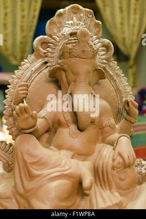 An unfinished clay idol of Lord Ganesha waiting to be painted for worship during Ganesh Chaturthi / Vinayaka Chaturthi festival. Stock Photo