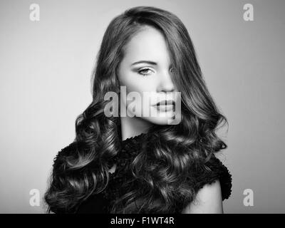 Portrait young beautiful woman with curly hair. Fashion photo Stock Photo