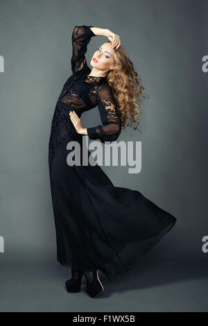 Portrait of beautiful brunette woman in black dress. Fashion photo Stock Photo
