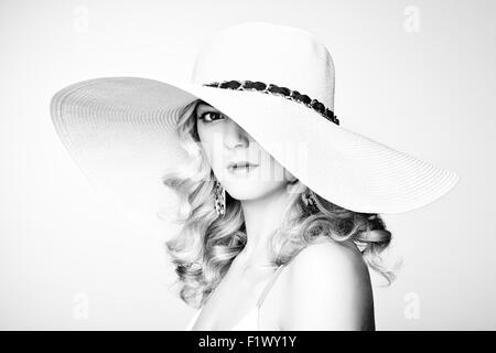 Fashion photo of young magnificent woman in hat. Girl posing. Studio photo. Blonde woman. Perfect Makeup Stock Photo