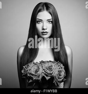 Portrait of beautiful dark-haired woman with flowers. Black and White photo Stock Photo