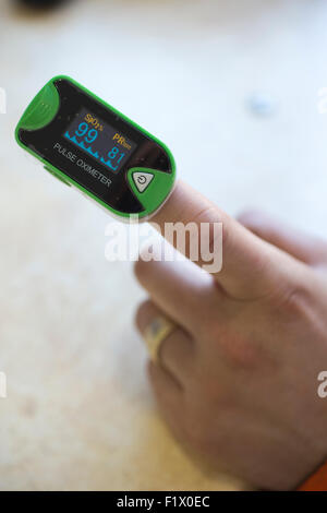 Construction workers taking a pulse reading and general health check on site, England, UK Stock Photo