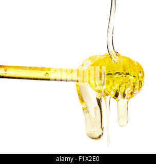 Honey dripping from a spoon on white background. Stock Photo