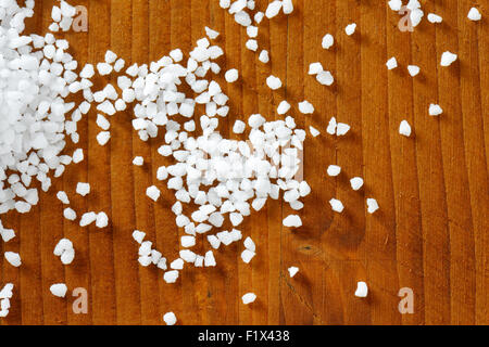 Coarse grained salt on wooden table Stock Photo