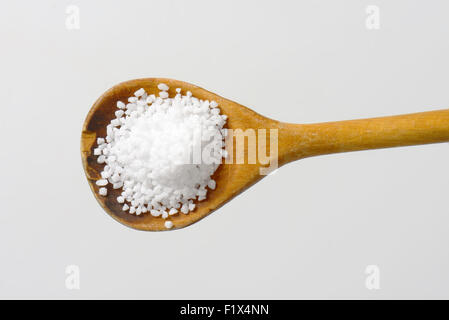 Coarse grained salt on wooden spoon Stock Photo