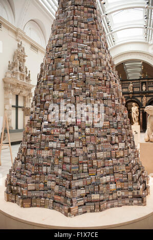 V&A, London, UK. 8th September, 2015. A six metre high installation created for the V&A by artist Barnaby Barford is displayed in the Museum’s Medieval & Renaissance Galleries until 1st November 2015. The Tower of Babel is composed of 3,000 individual bone china buildings, each depicting a real London shop. The Tower reflects London’s society and economy, at its base the shops are derelict, while at its pinnacle are London’s exclusive boutiques and galleries, with the Tower appearing more precarious towards the top. Credit:  Malcolm Park editorial/Alamy Live News Stock Photo