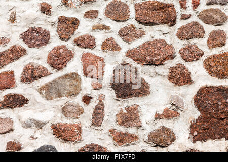 Fragment of a natural old stone wall as background Stock Photo