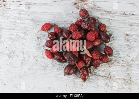 Dried rose hips berries on a wooden background. Stock Photo