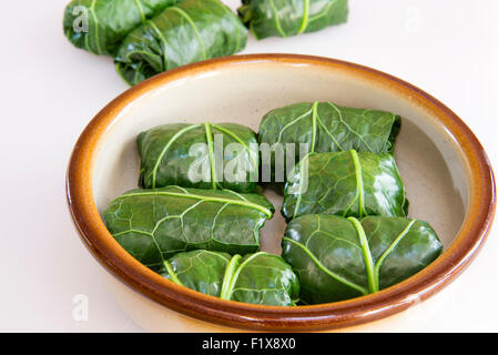 Freshly made rolls of stuffed cabbage leaves in a baking dish. Stock Photo